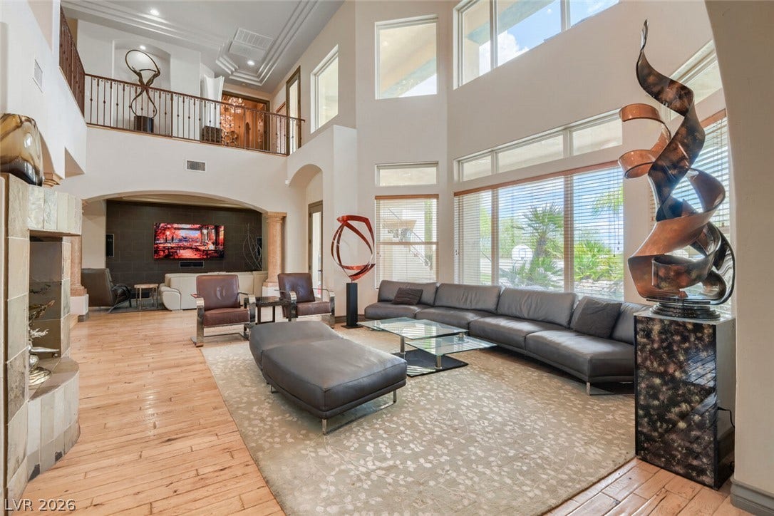 2010 Shenley Court, Las Vegas, NV 89117 Soaring ceilings and walls of windows define this light-filled great room with hardwood flooring.