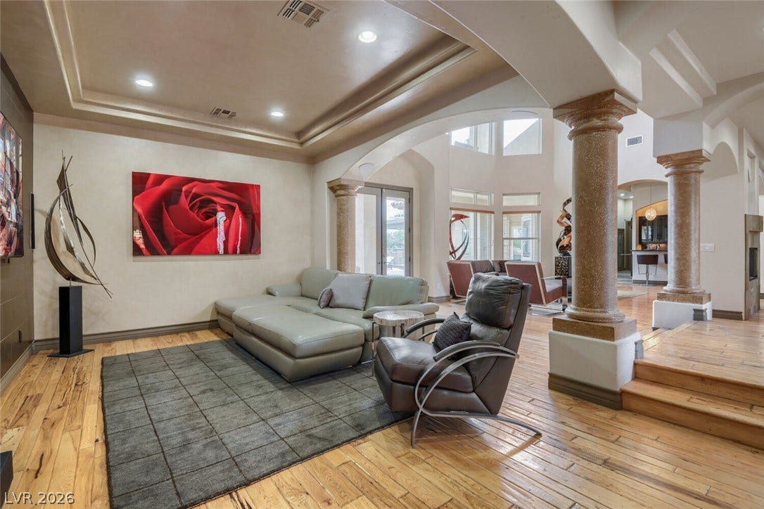 2010 Shenley Court, Las Vegas, NV 89117 Rich hardwood floors and elegant stone columns frame this spacious open-concept living area.