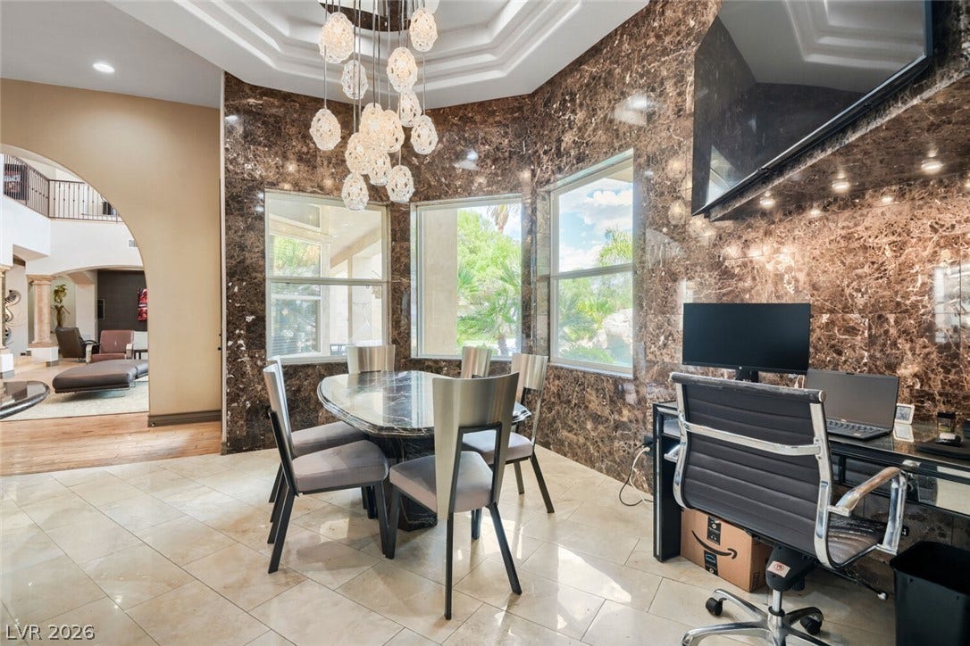 2010 Shenley Court, Las Vegas, NV 89117 Polished tile flooring and dramatic marble-paneled walls define this luminous dining and workspace area.