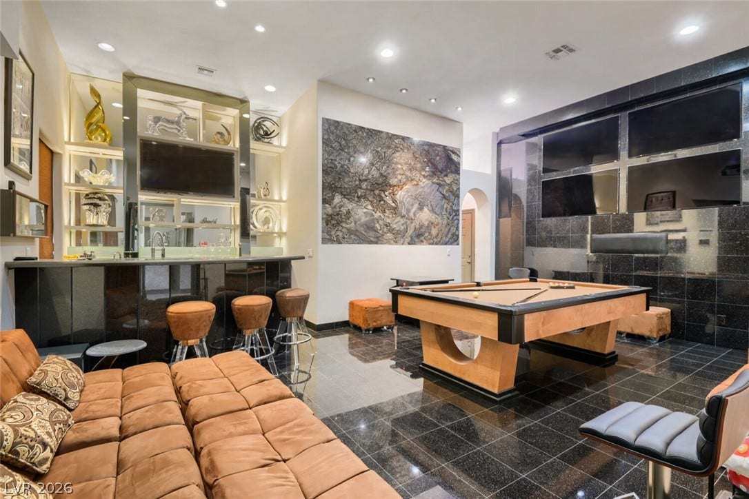 2010 Shenley Court, Las Vegas, NV 89117 Gleaming stone tile floors and structured lighting elevate this sprawling entertainment lounge and wet bar.