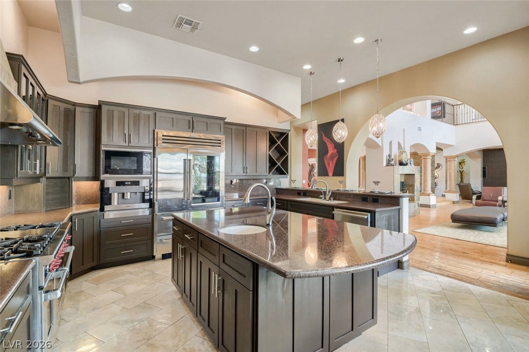 2010 Shenley Court, Las Vegas, NV 89117 Polished stone counters, custom cabinetry, and tile flooring define this architectural kitchen space.