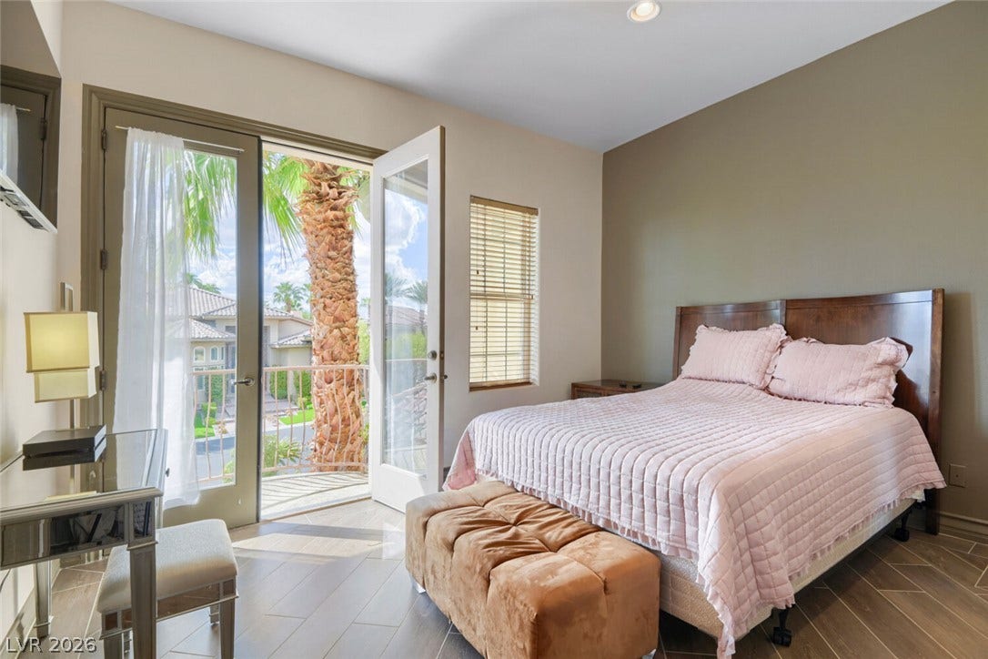 2010 Shenley Court, Las Vegas, NV 89117 Double doors open to a private balcony, filling this bedroom with natural light.