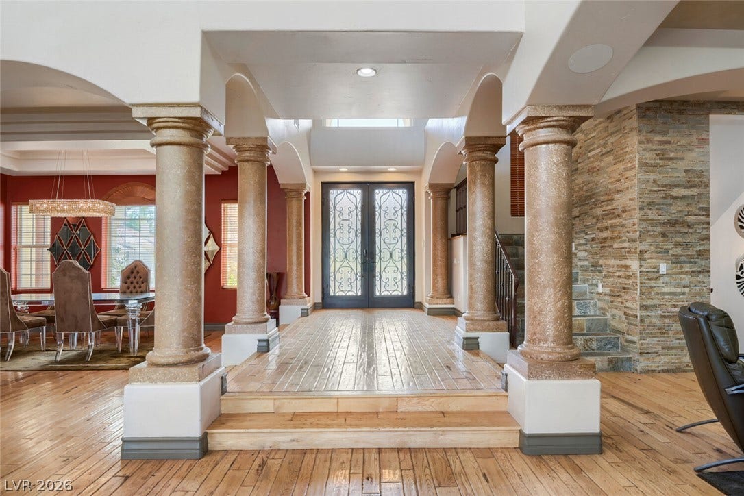 2010 Shenley Court, Las Vegas, NV 89117 Grand columns frame a spacious foyer featuring warm hardwood flooring and decorative double doors.