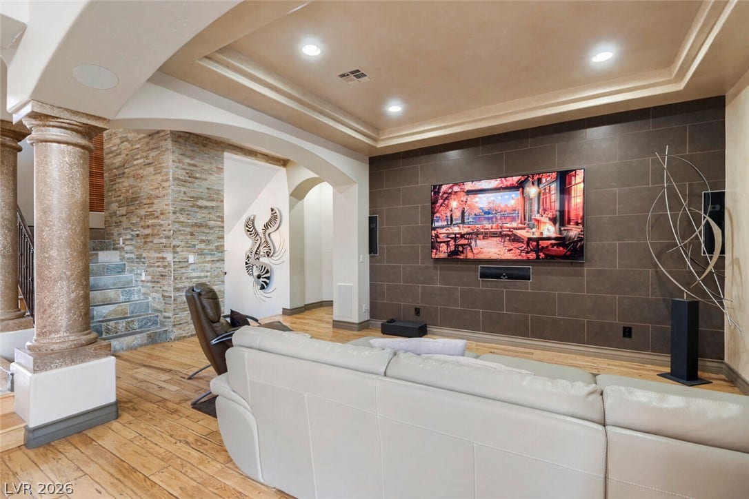 2010 Shenley Court, Las Vegas, NV 89117 Rich hardwood flooring complements the dramatic stone accent walls and elegant tray ceiling details.