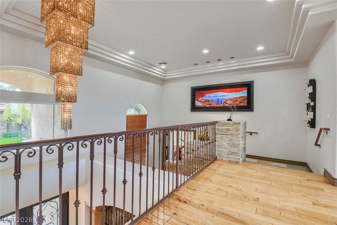 2010 Shenley Court, Las Vegas, NV 89117 Gleaming hardwood floors and a tiered tray ceiling define this elegant upper-level landing.