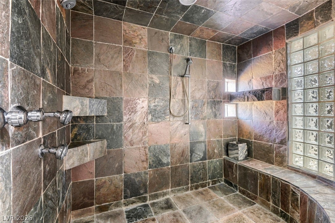 2010 Shenley Court, Las Vegas, NV 89117 Richly textured slate tile envelops this custom walk-in shower complete with built-in bench seating.