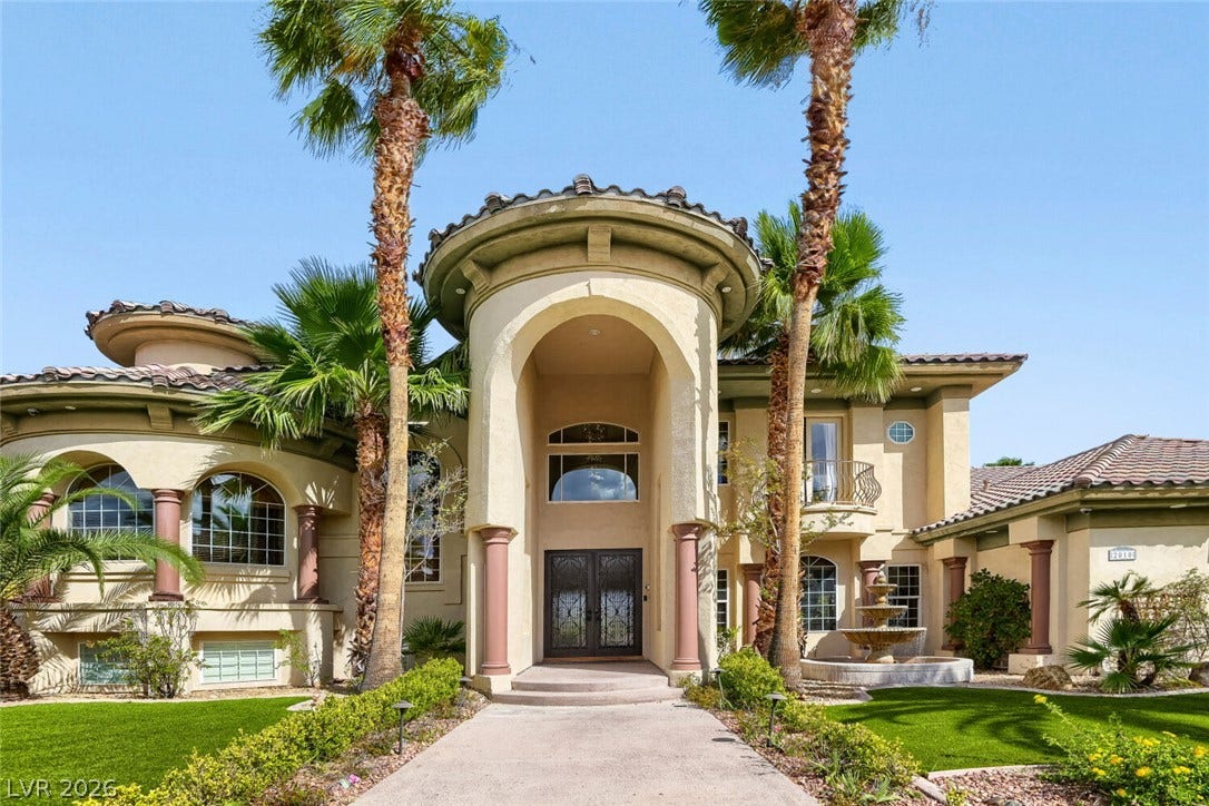 2010 Shenley Court, Las Vegas, NV 89117 A soaring arched entryway and barrel tile roofline define this impressive Mediterranean facade.