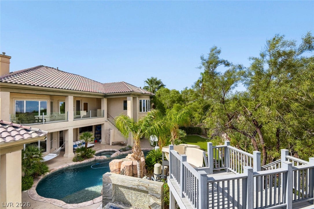 2010 Shenley Court, Las Vegas, NV 89117 Mature trees frame a private backyard retreat with a swimming pool and elevated wooden deck.