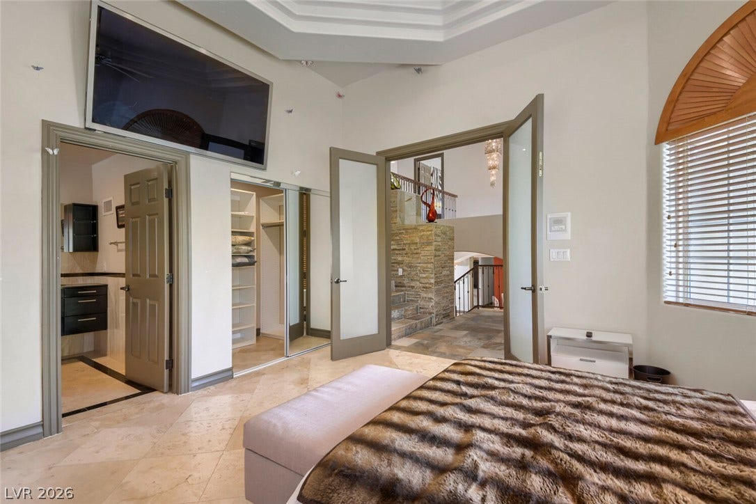 2010 Shenley Court, Las Vegas, NV 89117 High tray ceilings and polished stone tile floors define this architectural bedroom suite.