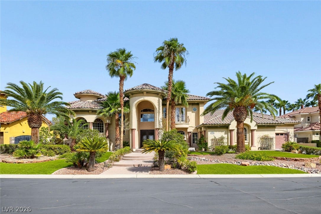 2010 Shenley Court, Las Vegas, NV 89117 Palm trees frame the arched entryway of this Mediterranean-inspired estate with tiled roofing.