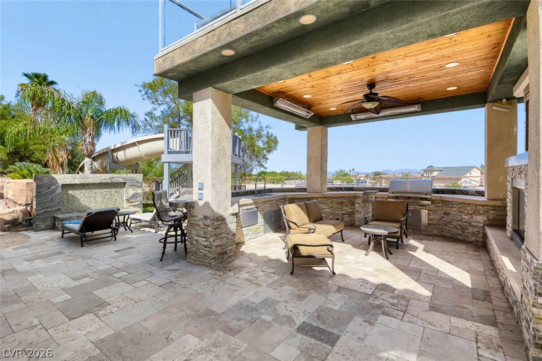 2010 Shenley Court, Las Vegas, NV 89117 Stone pillars support a wood-paneled ceiling sheltering this outdoor kitchen and dining terrace.