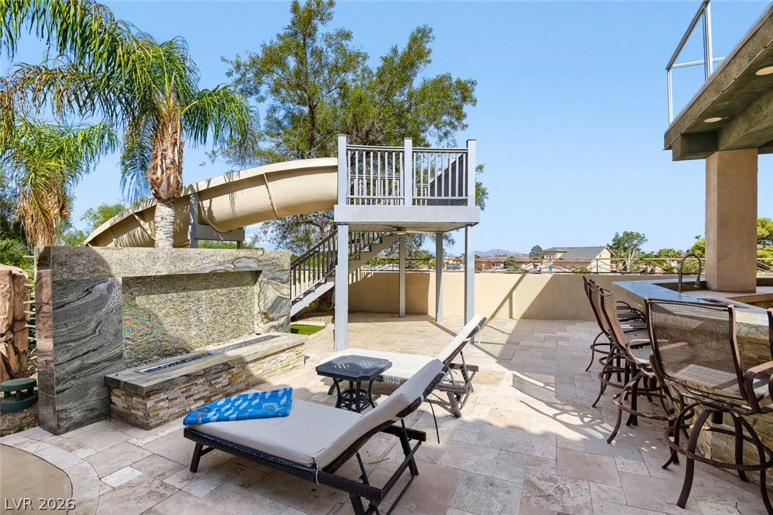 2010 Shenley Court, Las Vegas, NV 89117 Stone tile pavers and a custom fire feature enhance this outdoor terrace space.