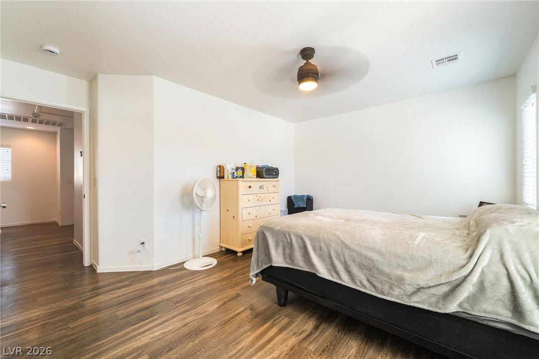 6275 Felicitas Avenue, Las Vegas, NV 89122 Gleaming wood floors anchor this comfortable bedroom complete with natural light.