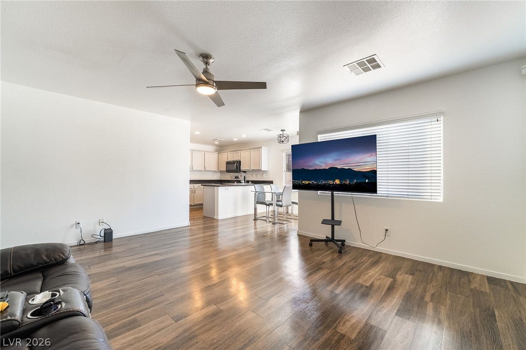 6275 Felicitas Avenue, Las Vegas, NV 89122 Gleaming wood flooring complements the airy, open layout of this versatile living area.
