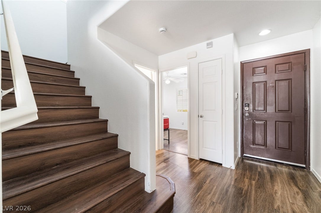 6275 Felicitas Avenue, Las Vegas, NV 89122 Rich wood-look flooring guides visitors from the entryway past a staircase into the home.
