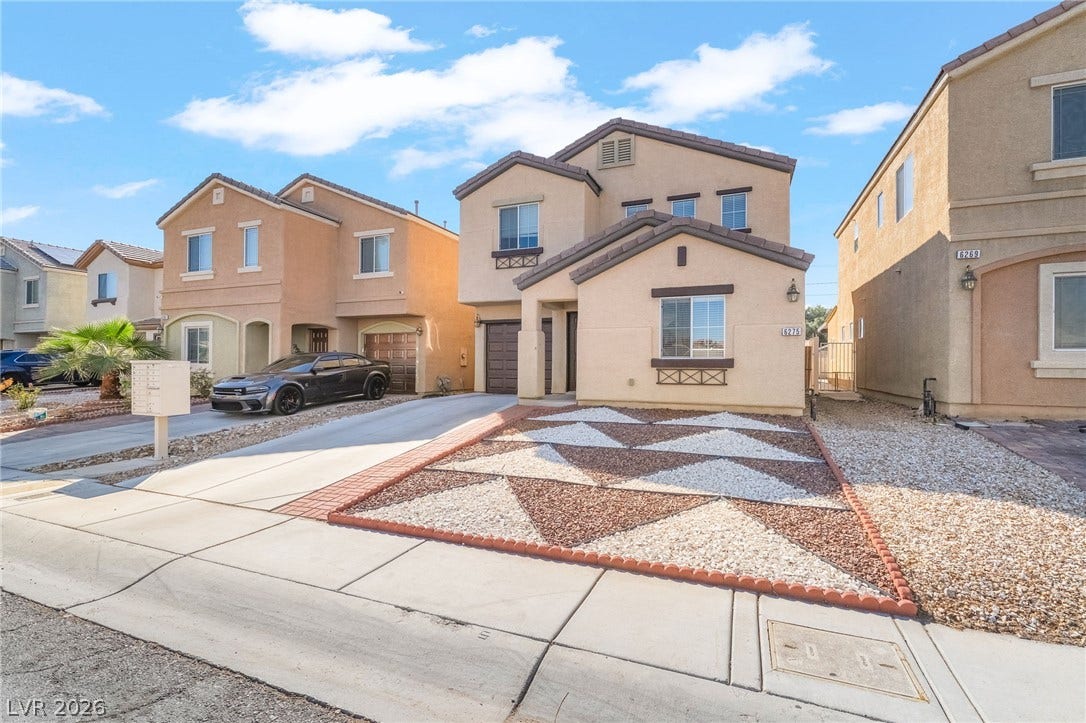 6275 Felicitas Avenue, Las Vegas, NV 89122 A classic stucco exterior frames this two-story home featuring low-maintenance desert landscaping.