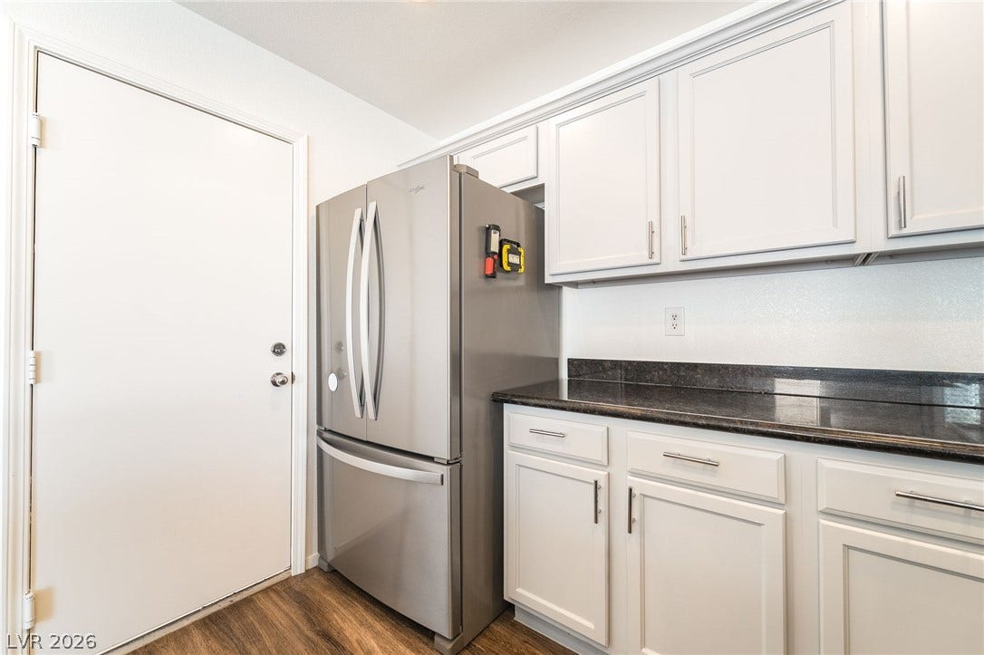 6275 Felicitas Avenue, Las Vegas, NV 89122 Polished stone countertops pair beautifully with crisp white cabinetry and rich wood floors.