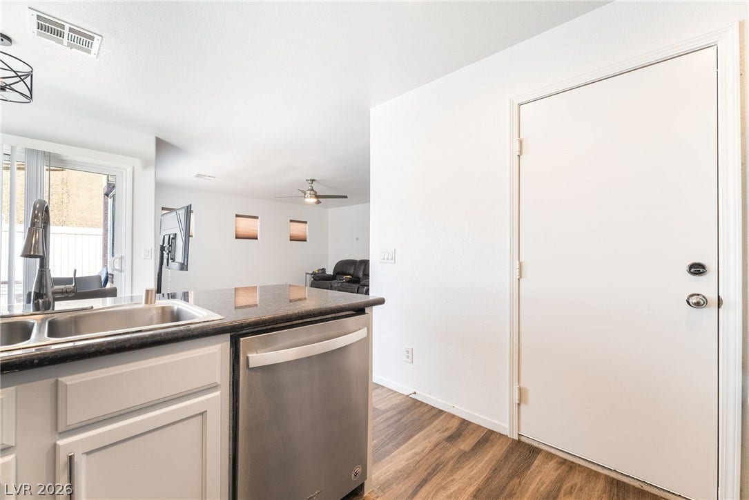 6275 Felicitas Avenue, Las Vegas, NV 89122 Gleaming stone countertops and warm wood floors define this open-concept culinary space.