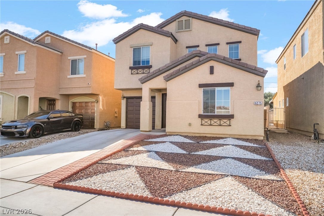6275 Felicitas Avenue, Las Vegas, NV 89122 Geometric desert landscaping complements the stucco facade of this modern multi-level residence.