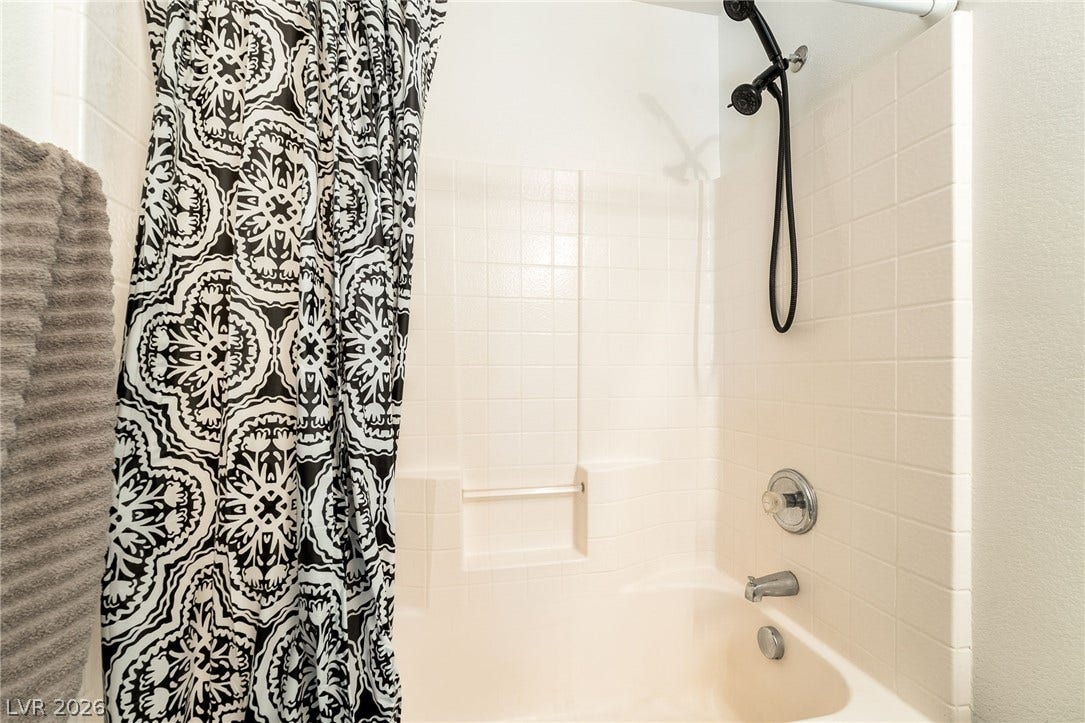 6275 Felicitas Avenue, Las Vegas, NV 89122 Clean tiling and a handheld showerhead complete this classic bathtub setup.
