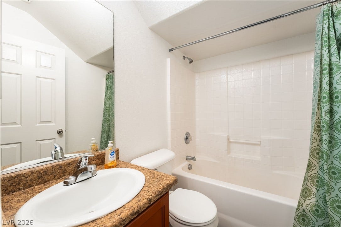 6275 Felicitas Avenue, Las Vegas, NV 89122 Granite counters and a classic tiled shower surround highlight this functional bathroom.