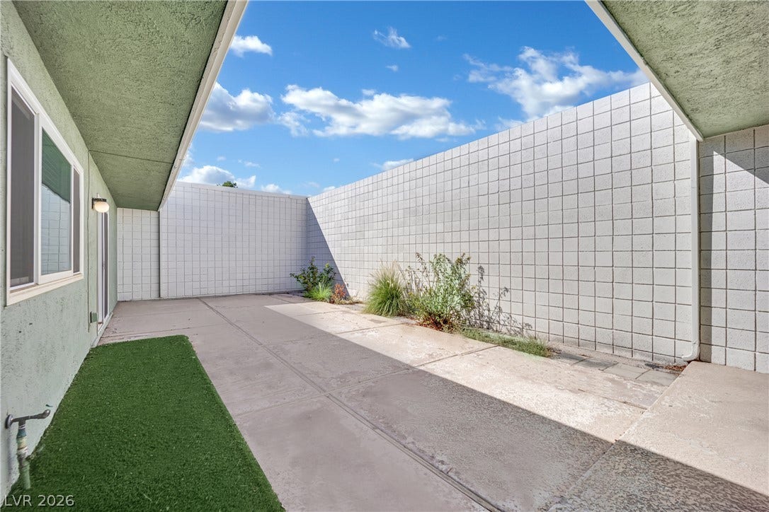 3753 Heritage Avenue, Las Vegas, NV 89121 High walls frame a private courtyard patio under open skies.