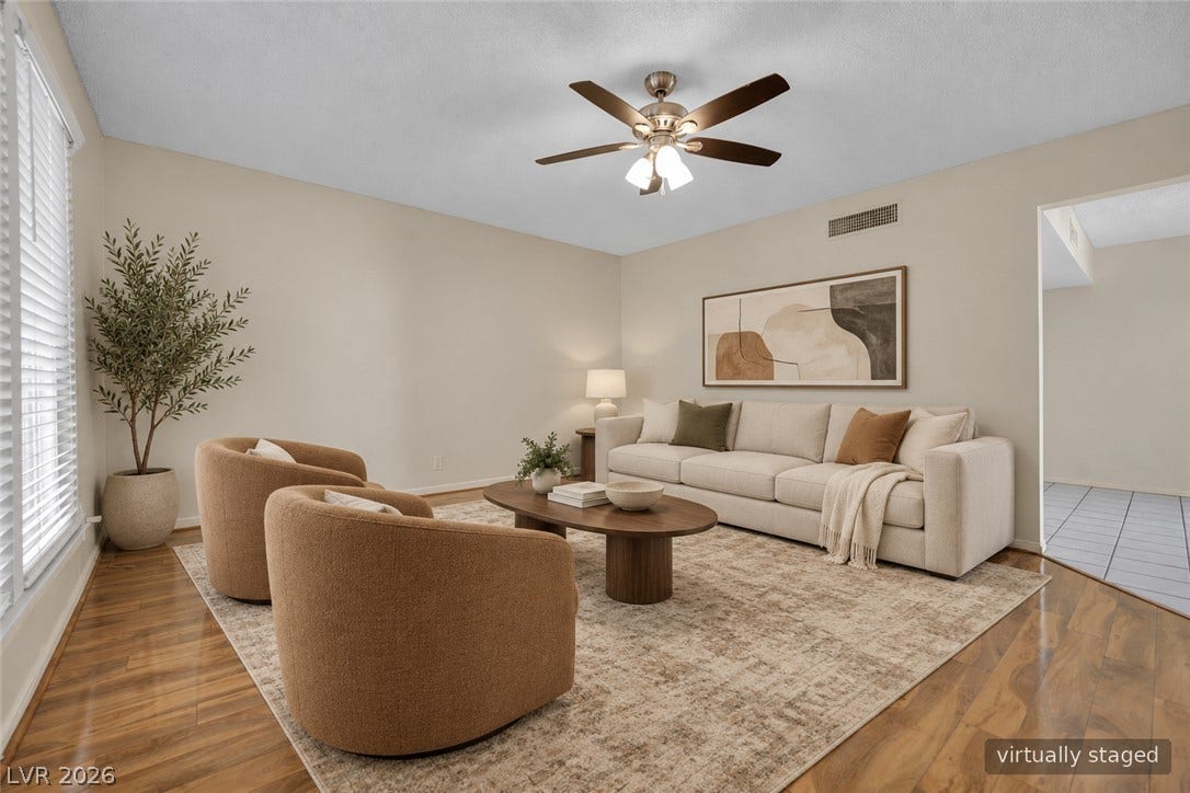 3753 Heritage Avenue, Las Vegas, NV 89121 Rich hardwood flooring complements the smooth neutral walls in this open living space.