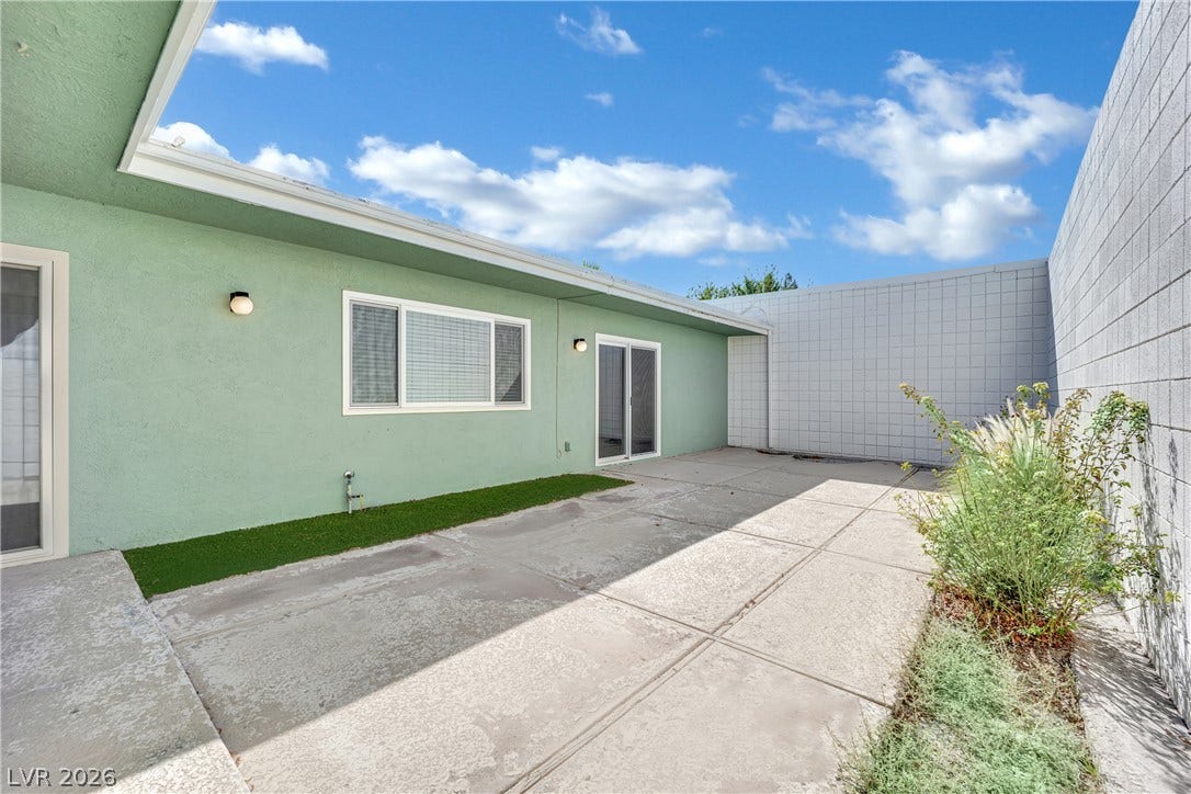 3753 Heritage Avenue, Las Vegas, NV 89121 Concrete paving extends across a private walled patio under open blue skies.