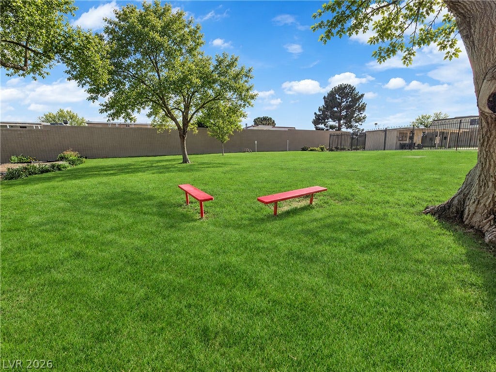3753 Heritage Avenue, Las Vegas, NV 89121 Mature trees shade a massive, level lawn fully enclosed by secure perimeter fencing.