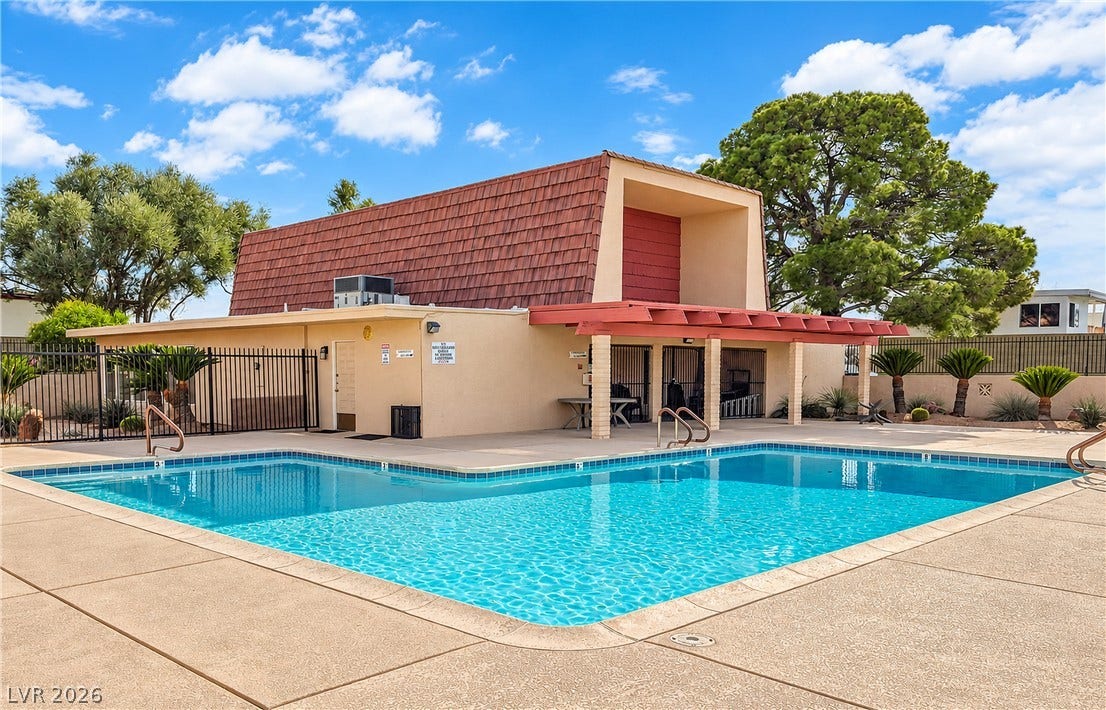 3753 Heritage Avenue, Las Vegas, NV 89121 An inviting swimming pool sits adjacent to a sheltered patio and a tiled-roof clubhouse.