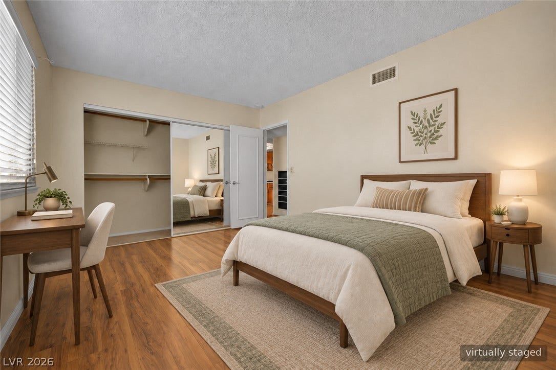3753 Heritage Avenue, Las Vegas, NV 89121 Warm wood flooring and mirrored closet doors enrich this inviting bedroom retreat.