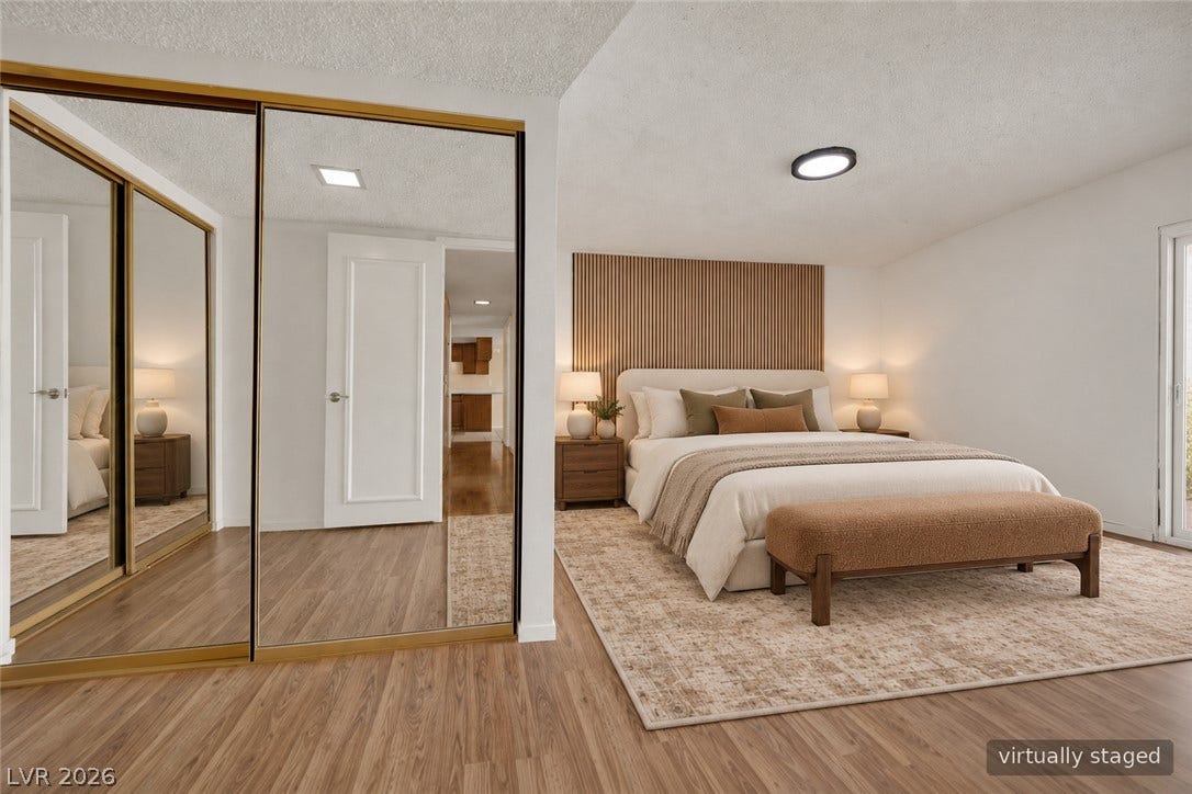 3753 Heritage Avenue, Las Vegas, NV 89121 A spacious bedroom features sleek wood flooring and a large mirrored closet.