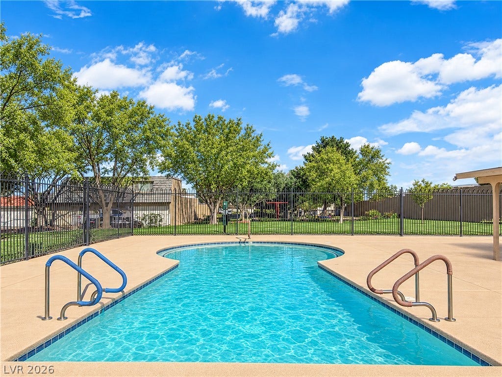 3753 Heritage Avenue, Las Vegas, NV 89121 An inviting swimming pool is enclosed by secure fencing and framed by mature trees.