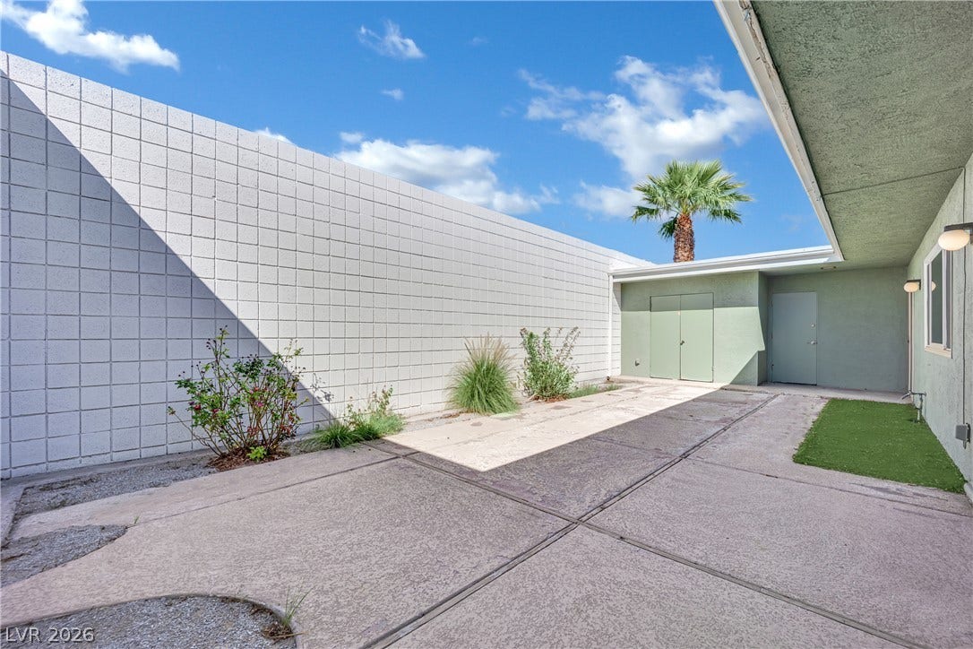 3753 Heritage Avenue, Las Vegas, NV 89121 High concrete block walls frame this private courtyard entryway under wide open desert skies.