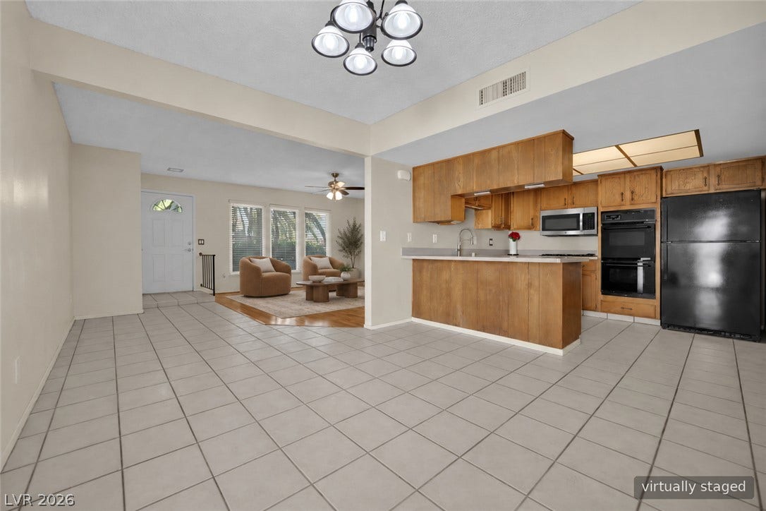 3753 Heritage Avenue, Las Vegas, NV 89121 An open floor plan flows effortlessly from the tiled kitchen area into the living space.