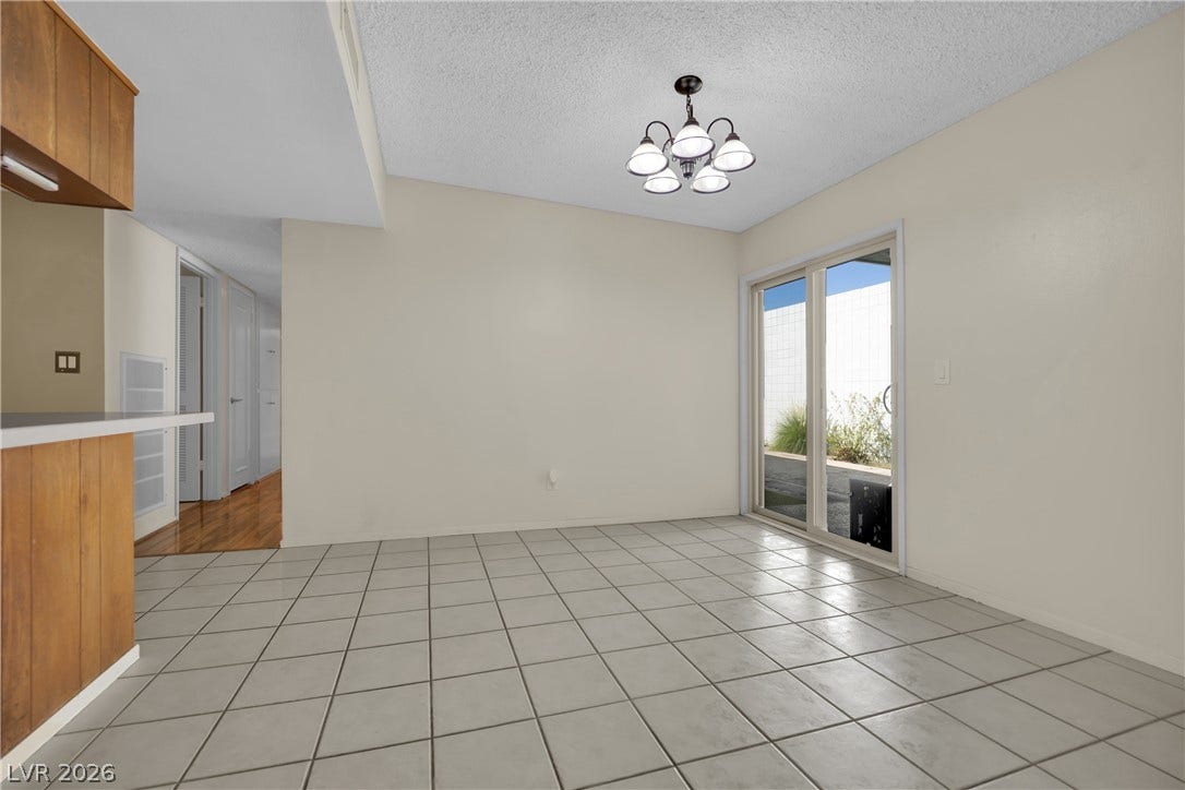 3753 Heritage Avenue, Las Vegas, NV 89121 Tiled flooring and sliding glass doors highlight this versatile dining space adjacent to the kitchen.