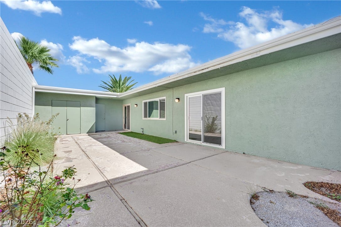 3753 Heritage Avenue, Las Vegas, NV 89121 Sliding glass doors open directly to a spacious concrete patio under blue skies.