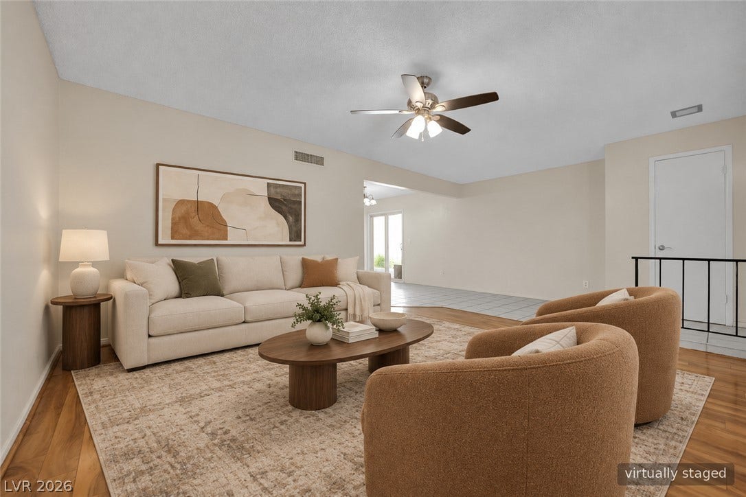 3753 Heritage Avenue, Las Vegas, NV 89121 Rich hardwood flooring anchors this versatile space opening to an adjacent tiled dining area.
