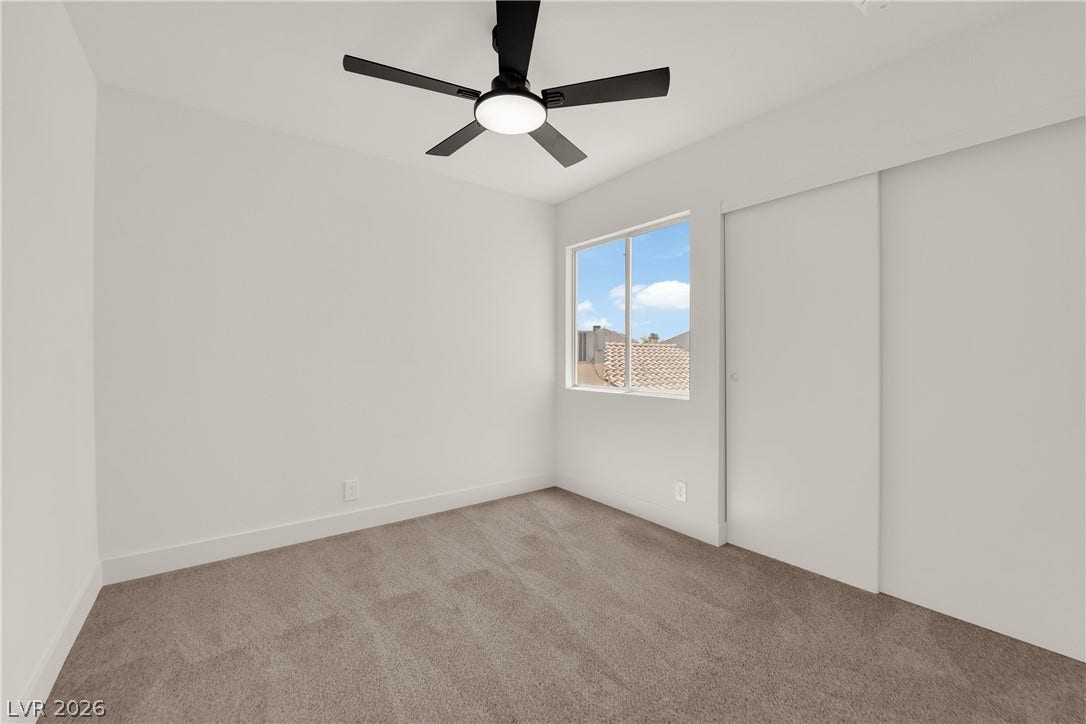 Soft carpeting underfoot and a clean modern aesthetic define this comfortable bedroom space.