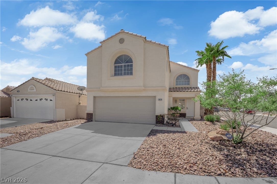 Arched windows and clean stucco surfaces define this two-story exterior facade.