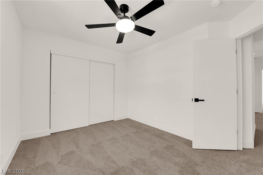 Soft carpeting underfoot anchors this minimalist space featuring crisp white walls.
