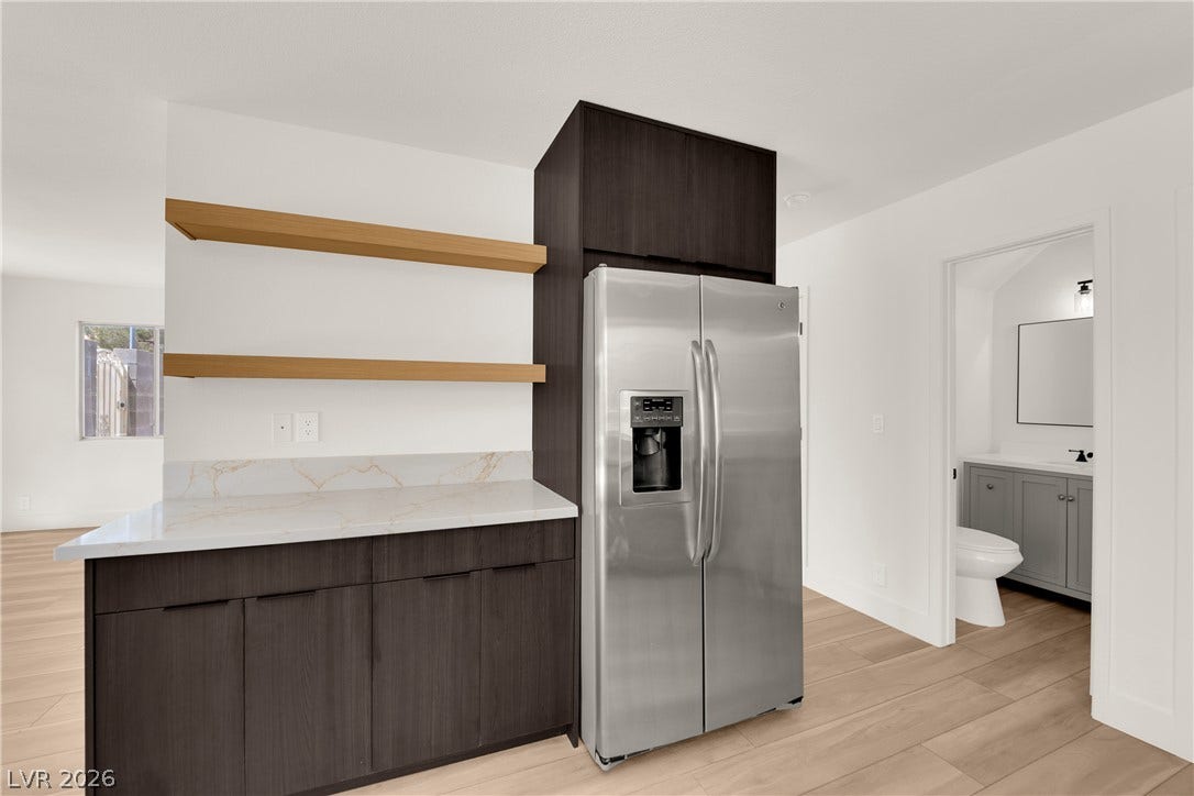 Clean lines and warm wood tones define this modern dry bar setup.