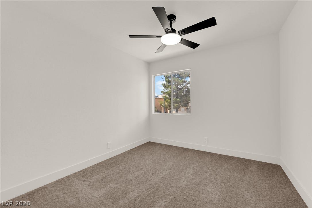 Plush carpeting and a picture window detailing views of the surrounding neighborhood highlight this space.