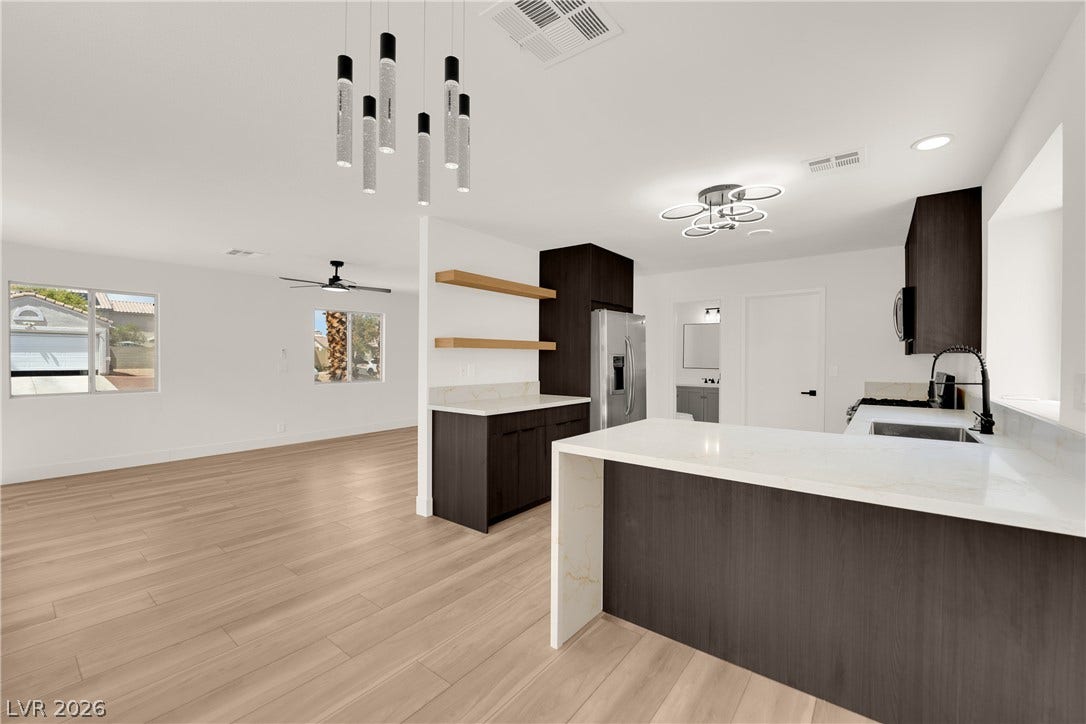 Crisp white walls and clean architectural lines define this modern open-concept living space.