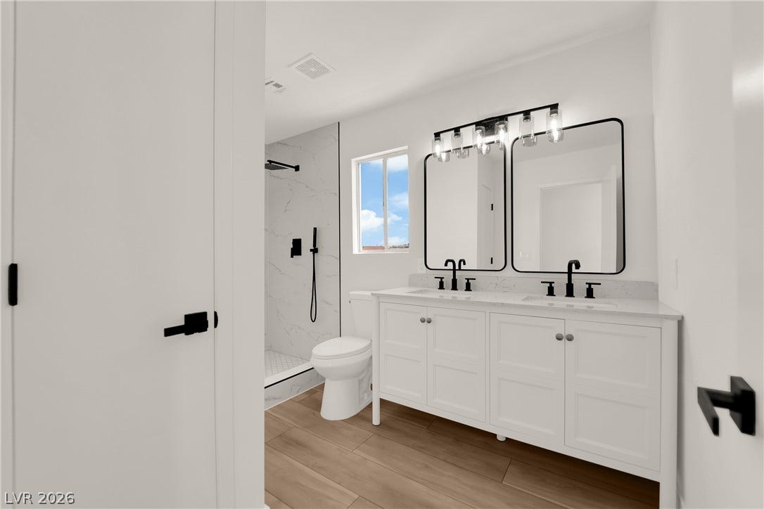 Clean lines and a dual sink vanity highlight this contemporary bathroom space.