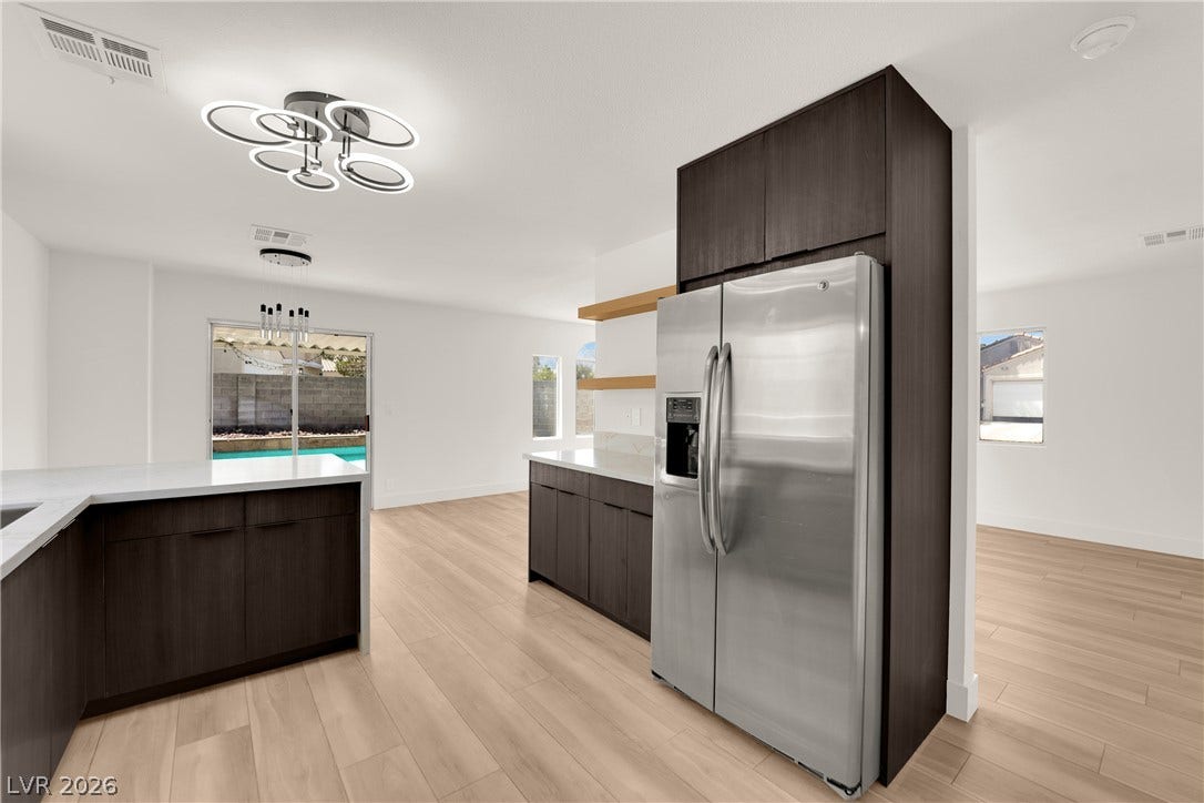 Streamlined cabinetry and clean countertops frame this modern culinary space.