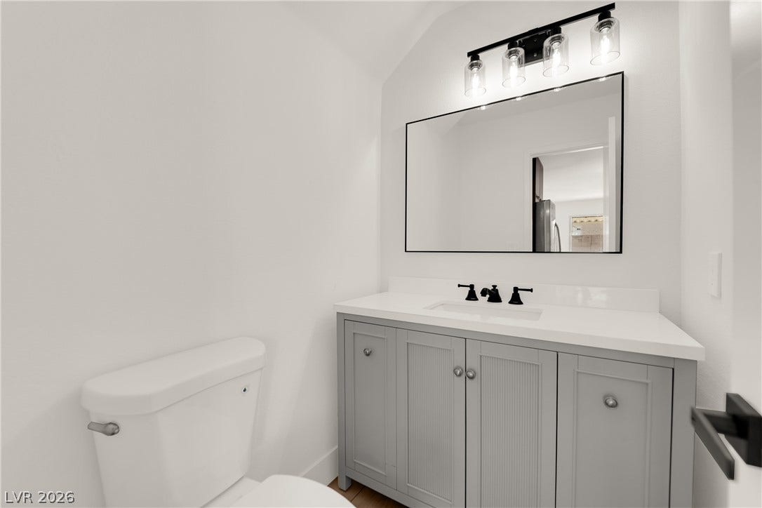 Clean lines and a stylish vanity define this modern powder room.