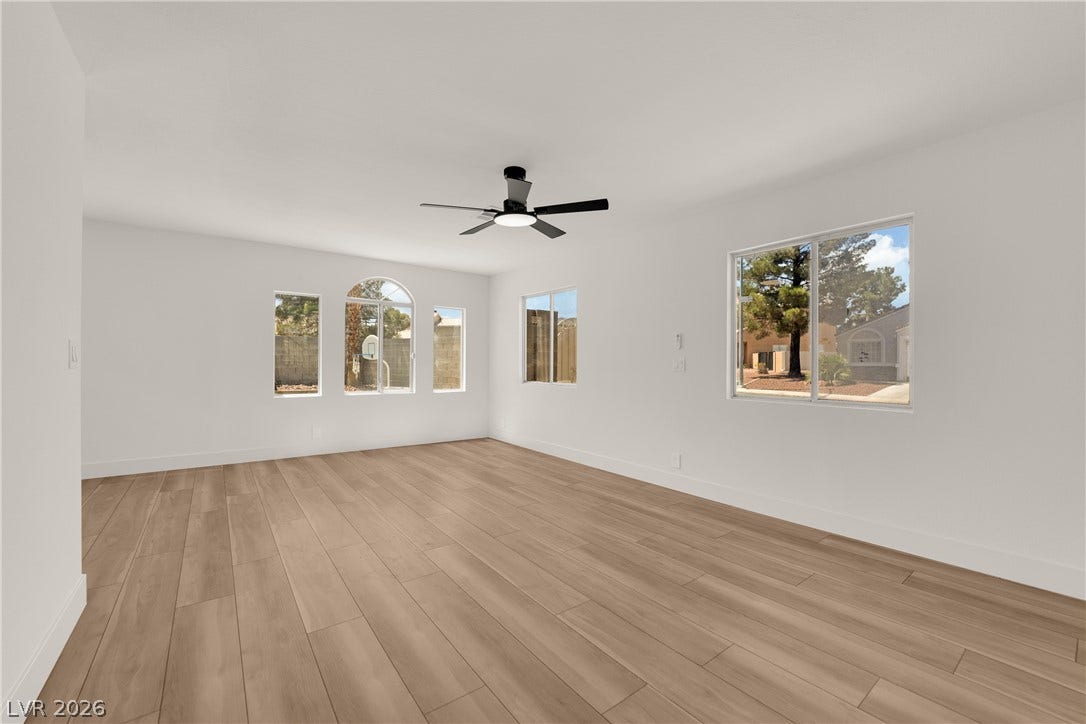 Smooth wood floors and tall windows define this open interior space.