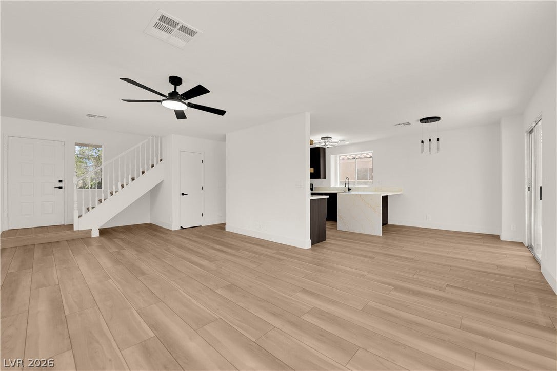 Clean lines and smooth wood floors define this light-filled, open-concept living and dining area.