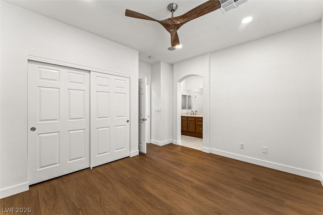 215 Sunset Shower Drive, Henderson, NV 89012 Rich wood-inspired floors and recessed lighting enhance this versatile bedroom layout.